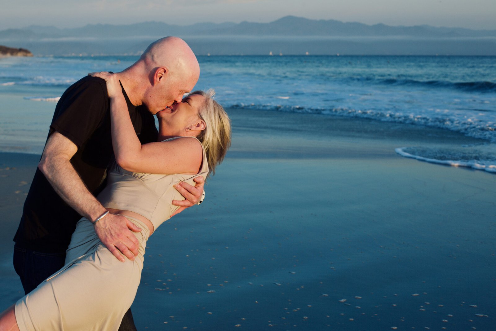 Photo of a couple kissing in the beach