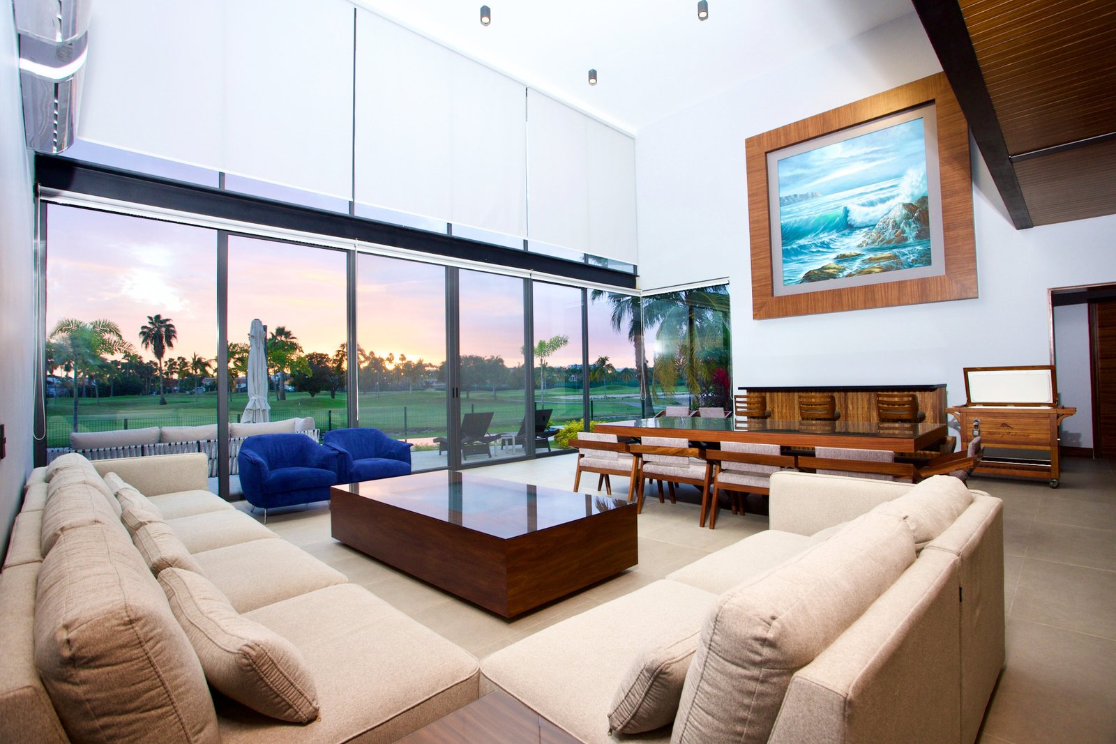 An architectural photography of a living room with a golf course at the background