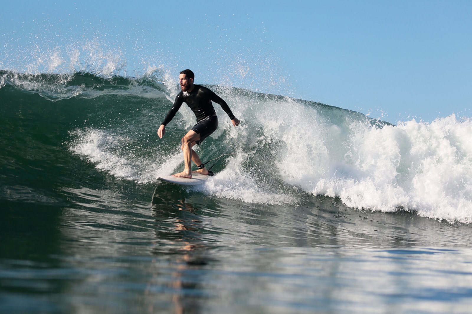 A young man surfing a big wave in the sea